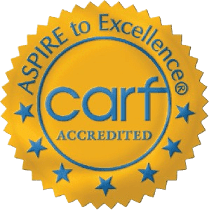 A circular logo with the words "CARF Accredited" in bold letters, surrounded by a blue border.